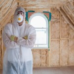 Man standing in protective suit after installing insulation
