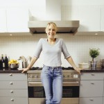 Young woman standing in front of her stove