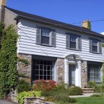 Suburban home with siding and vines