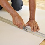 Hands of man cutting drywall with utility knife